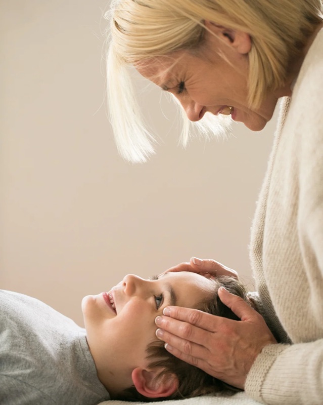 Annica Larsdotter using cranial technique during a paediatric chiropractic assessment
