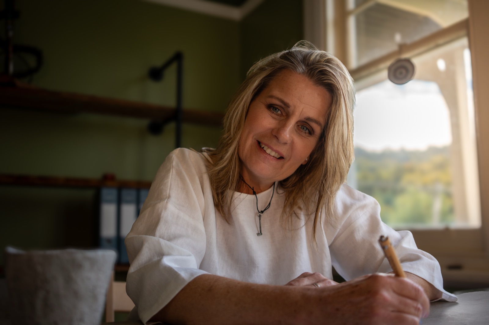 Annica Larsdotter at her desk — care for headaches and migraines