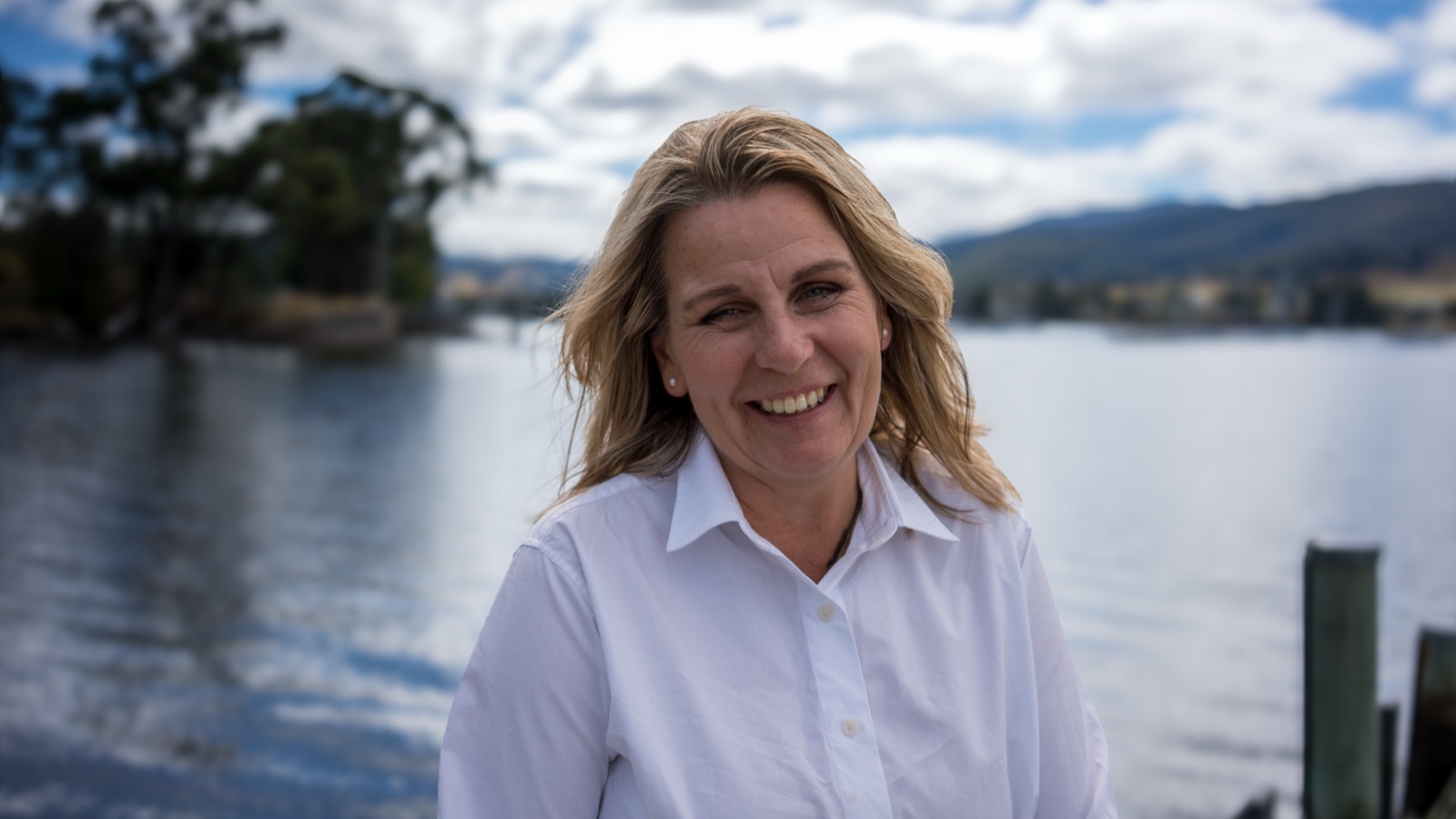 Annica Larsdotter smiling by the waterfront — welcoming new patients